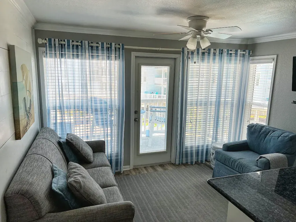 Seascape Condo 2208 vacation rental in Galveston — coastal living room with balcony access