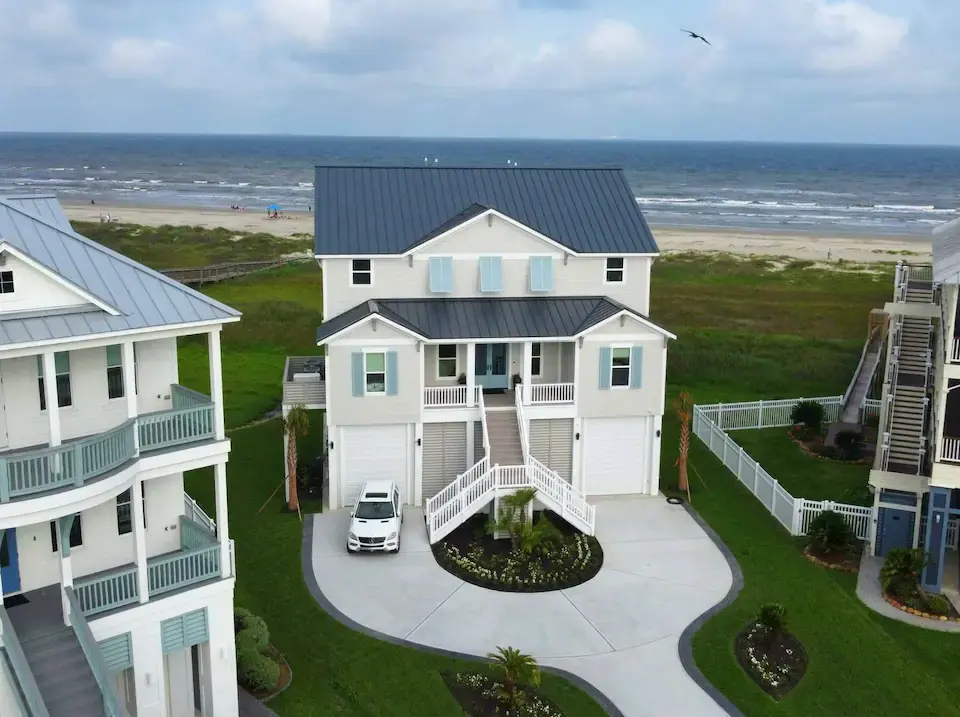 Fishwife vacation rental in Galveston — beachfront house with dual staircases and gulf backdrop