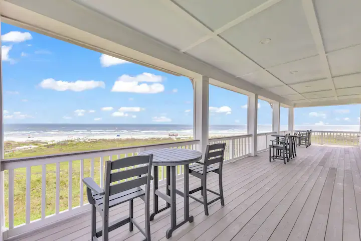 Covered top-floor deck with bistro tables overlooking the beach and gulf at Fishwife