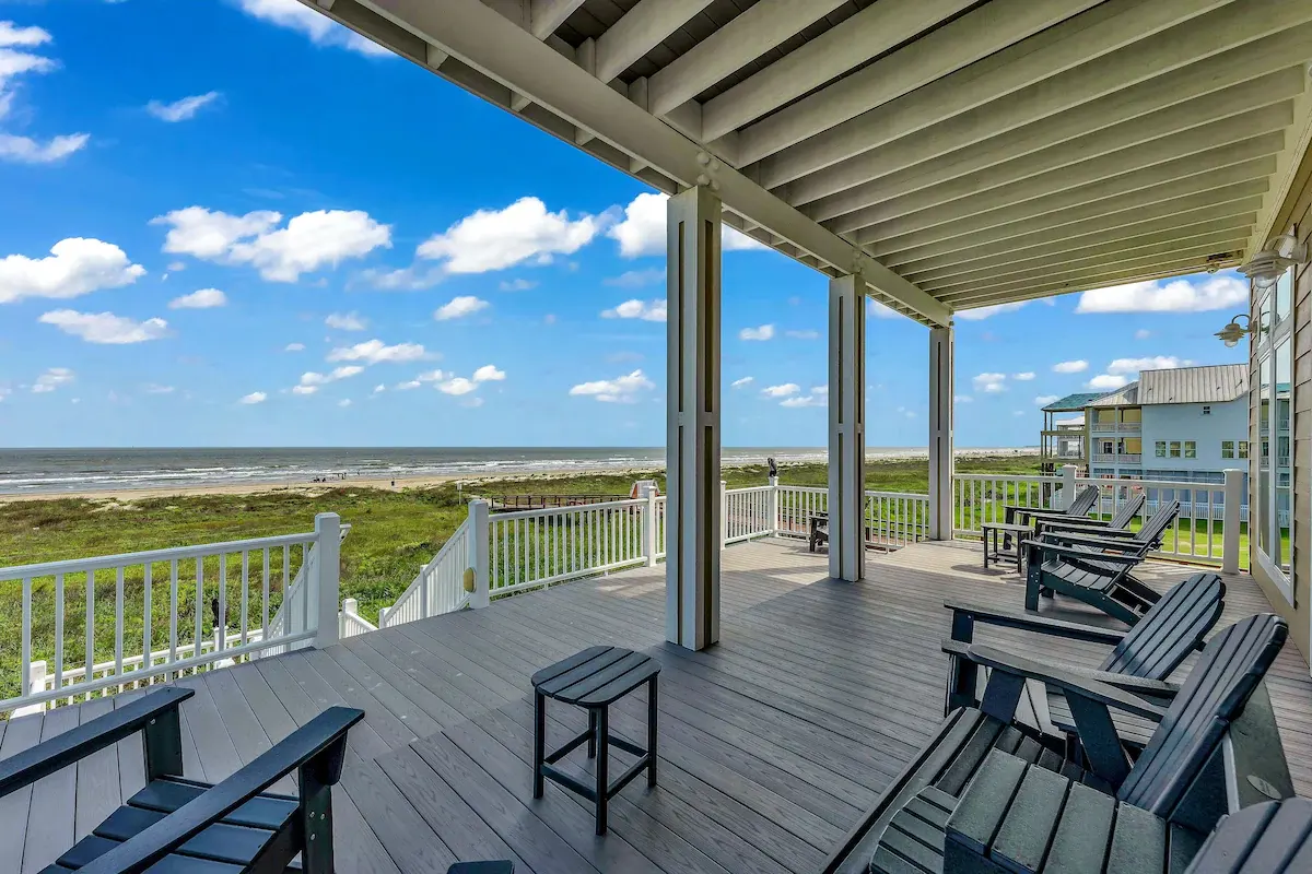Covered deck at Sandy Sea-cret with Adirondack chairs facing the gulf