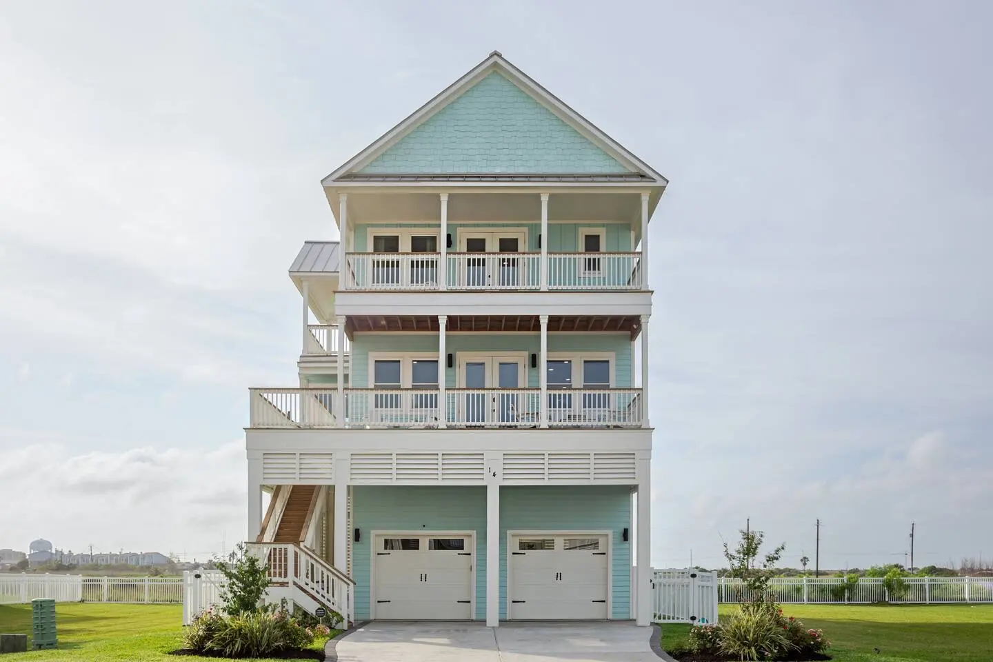 Alma de Mar vacation rental in Galveston — seafoam three-story beach house with stacked porches