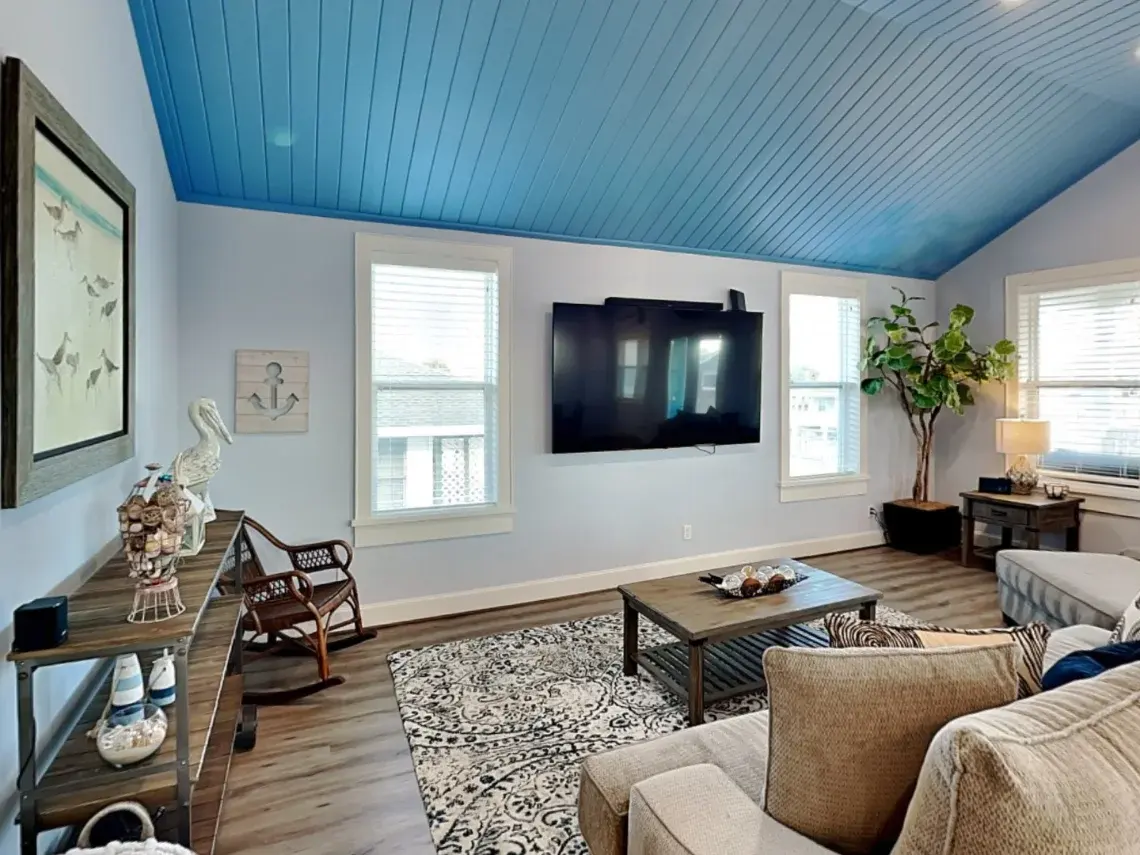 Bright family room with sectional sofa and doors to the deck at Tiki Retreat