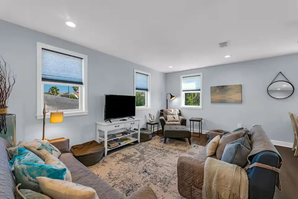 Oasis by the Bay vacation rental in Galveston — coastal living room with plush sofas and beach decor