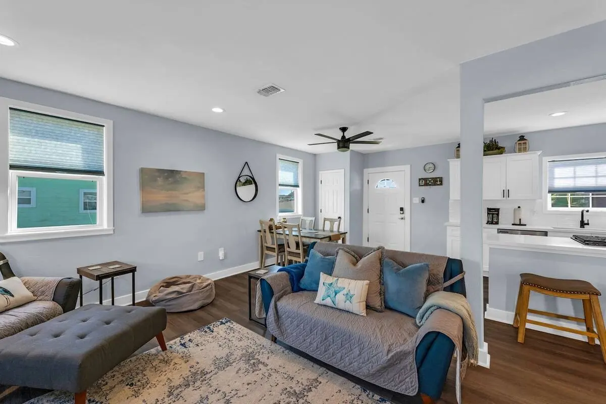 Open living and dining area flowing into the white kitchen at Oasis by the Bay