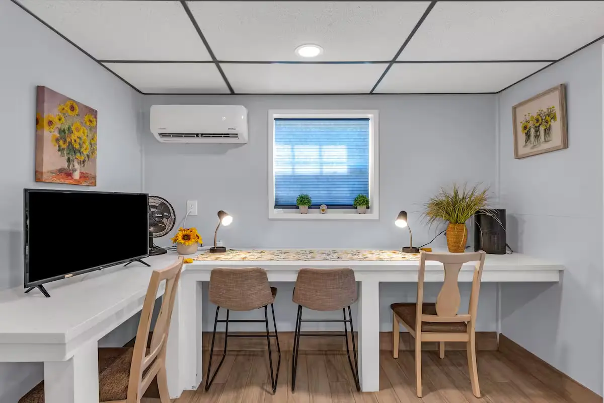 Work-friendly desk nook with task lamps and sunflower art at Oasis by the Bay