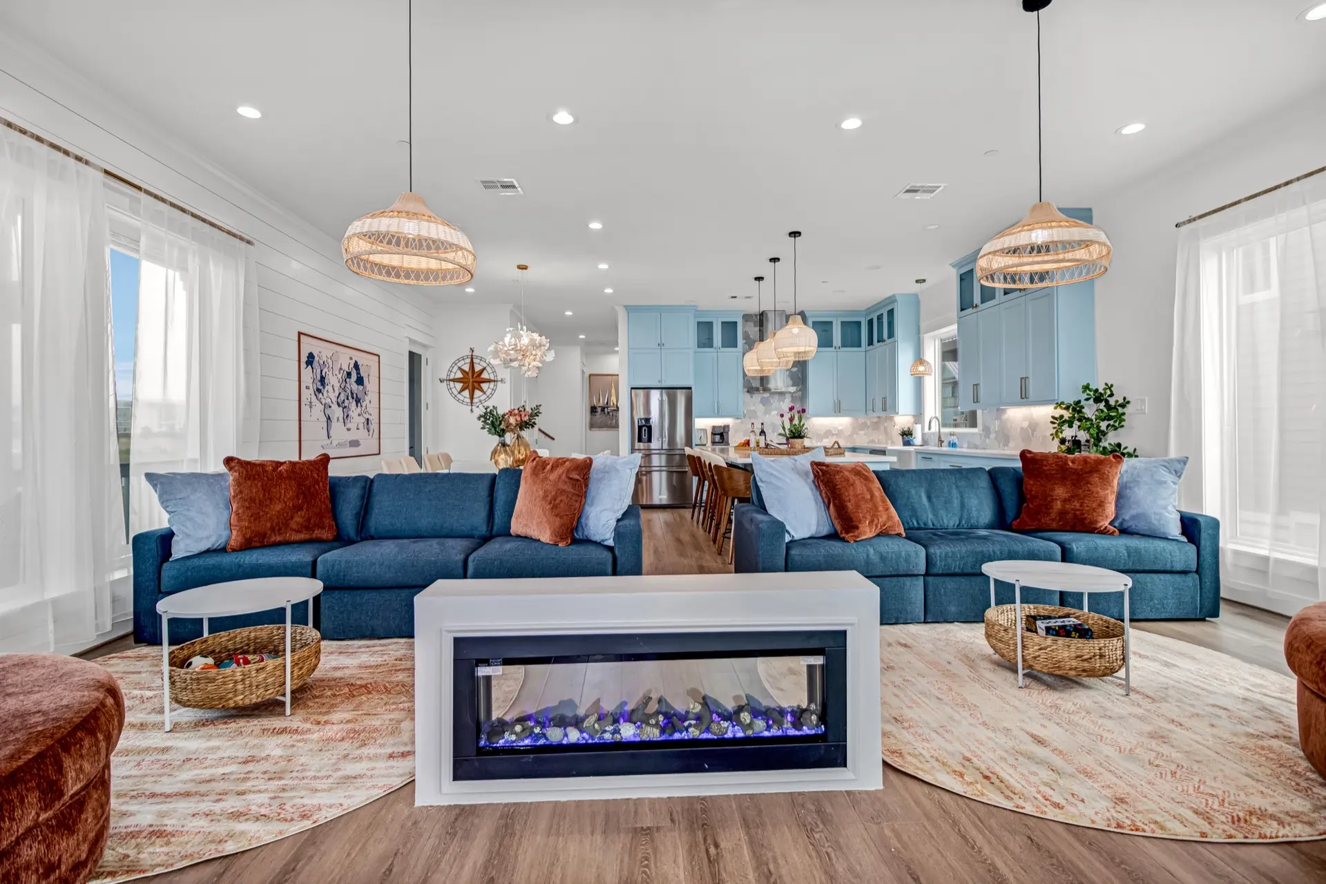 Grand Beach Retreat vacation rental in Galveston — living room with blue sectionals and fireplace